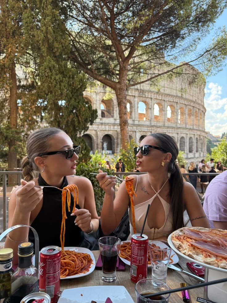 Friends sharing pasta during a group weekend in Rome